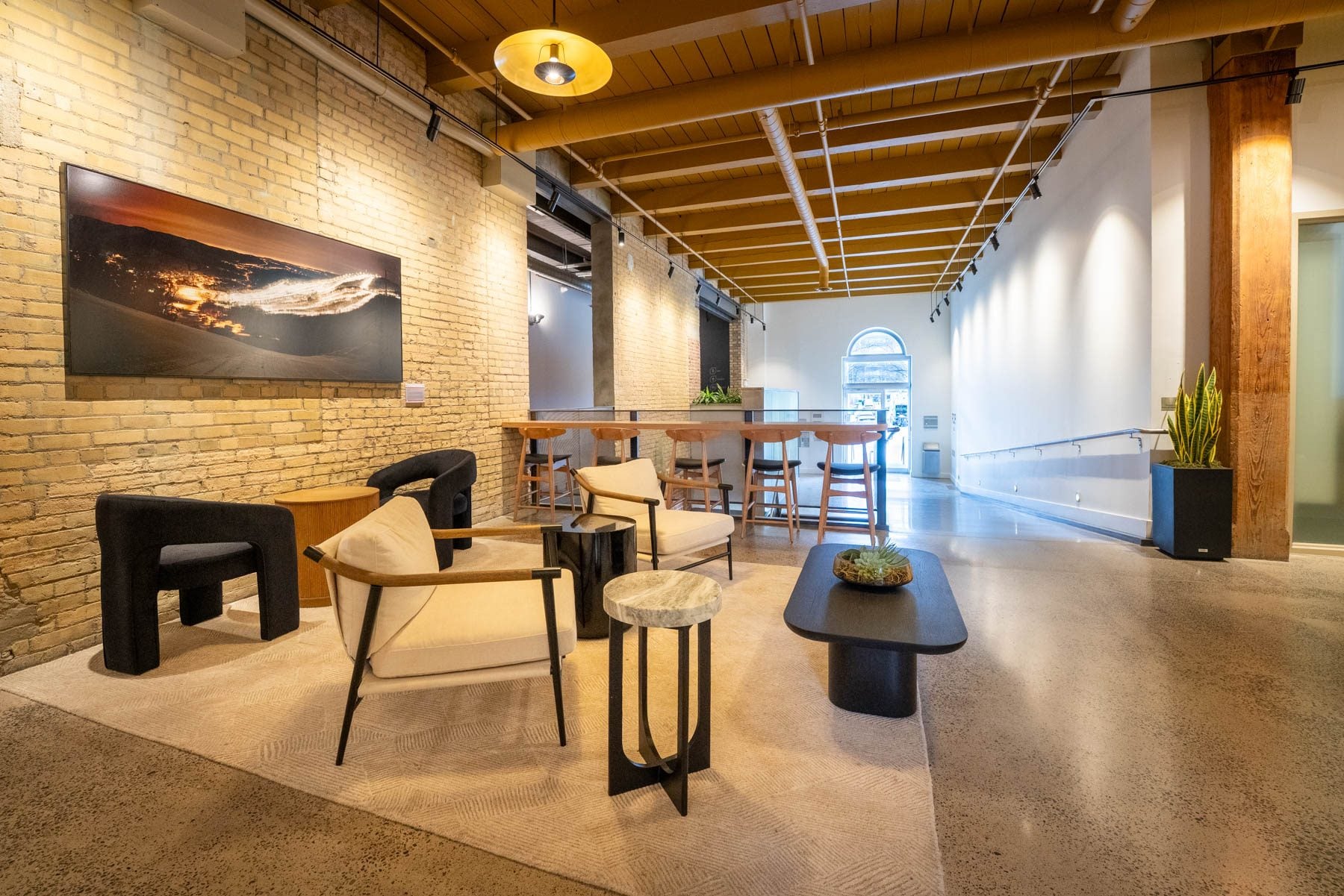 The renovated main lobby at Light Factory with lounge seating under original timber beams