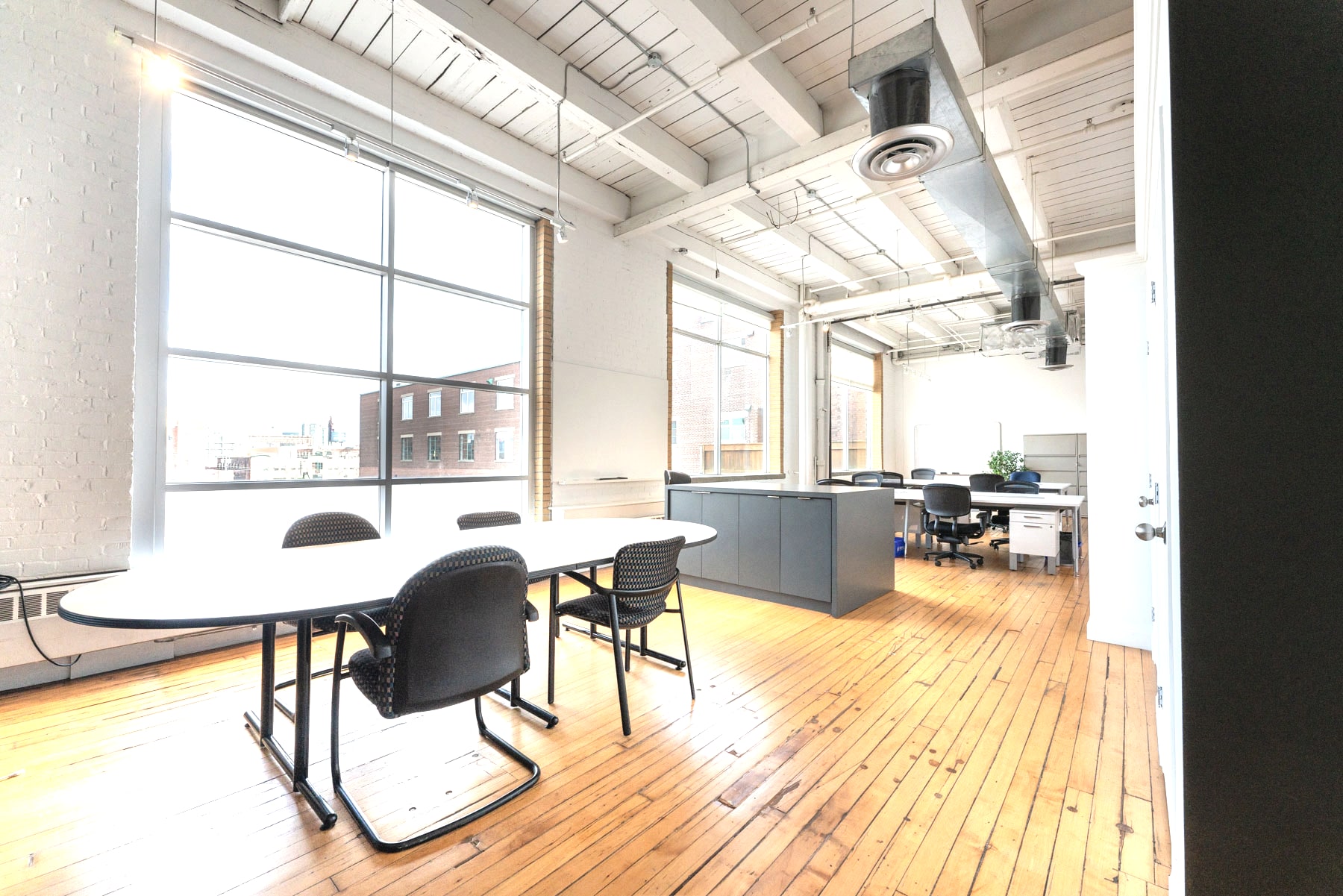 A furnished suite with exposed beams and downtown views